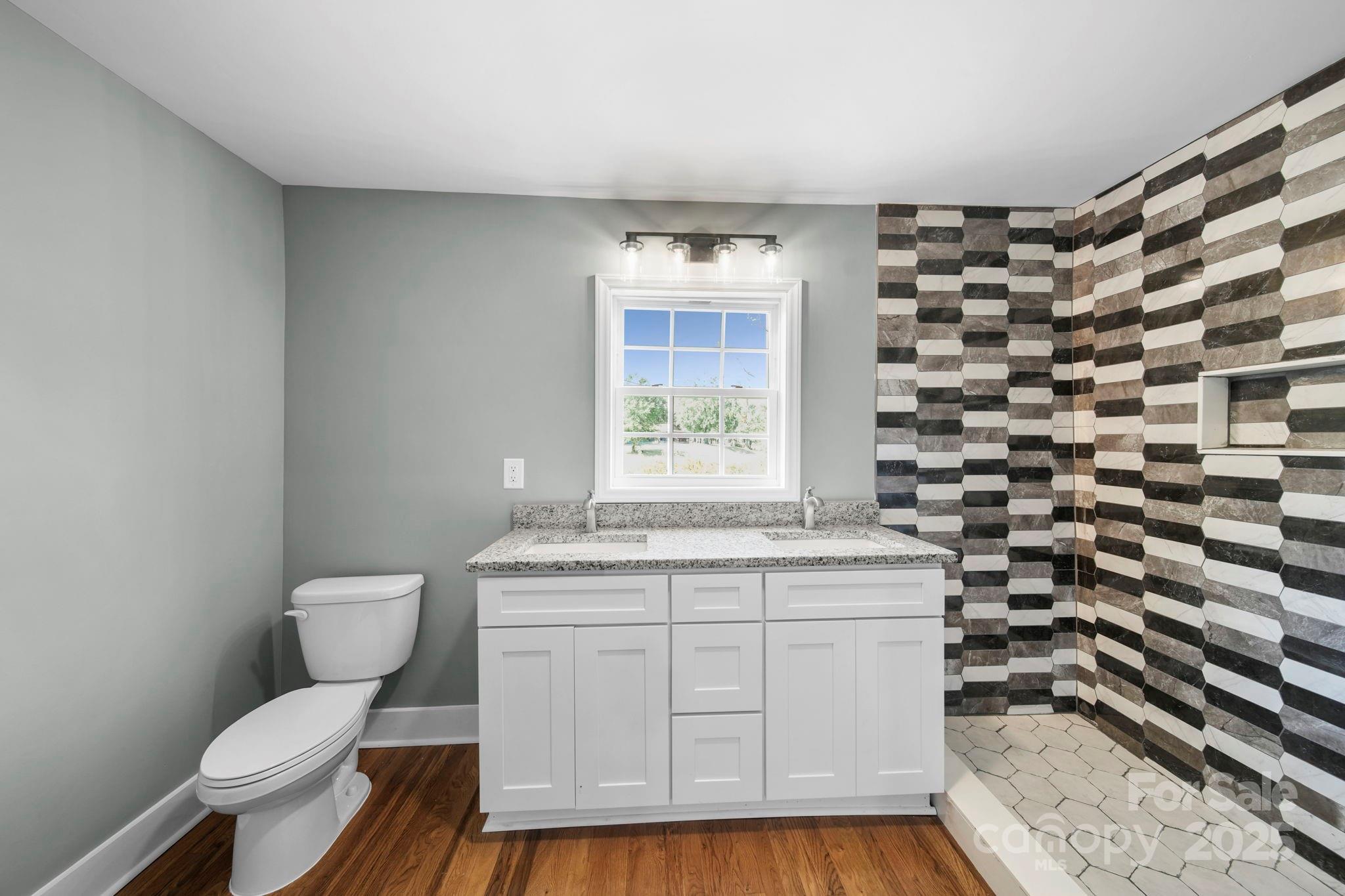 1048 Bowers Road Peachland, NC 28133 - Photo 40 of 44 a bathroom with a granite countertop toilet a sink and a bathtub