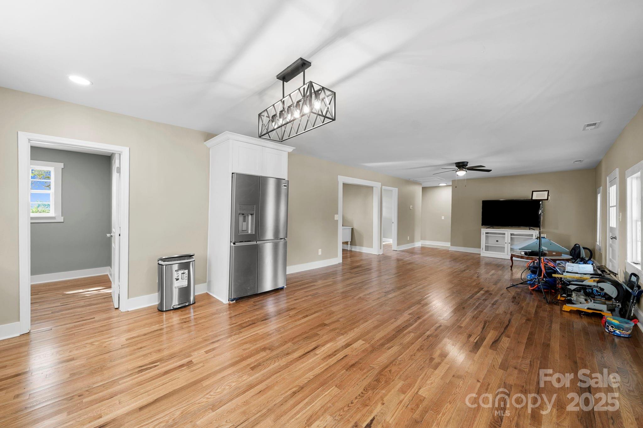 1048 Bowers Road Peachland, NC 28133 - Photo 9 of 44 a view of a livingroom with wooden floor and a kitchen