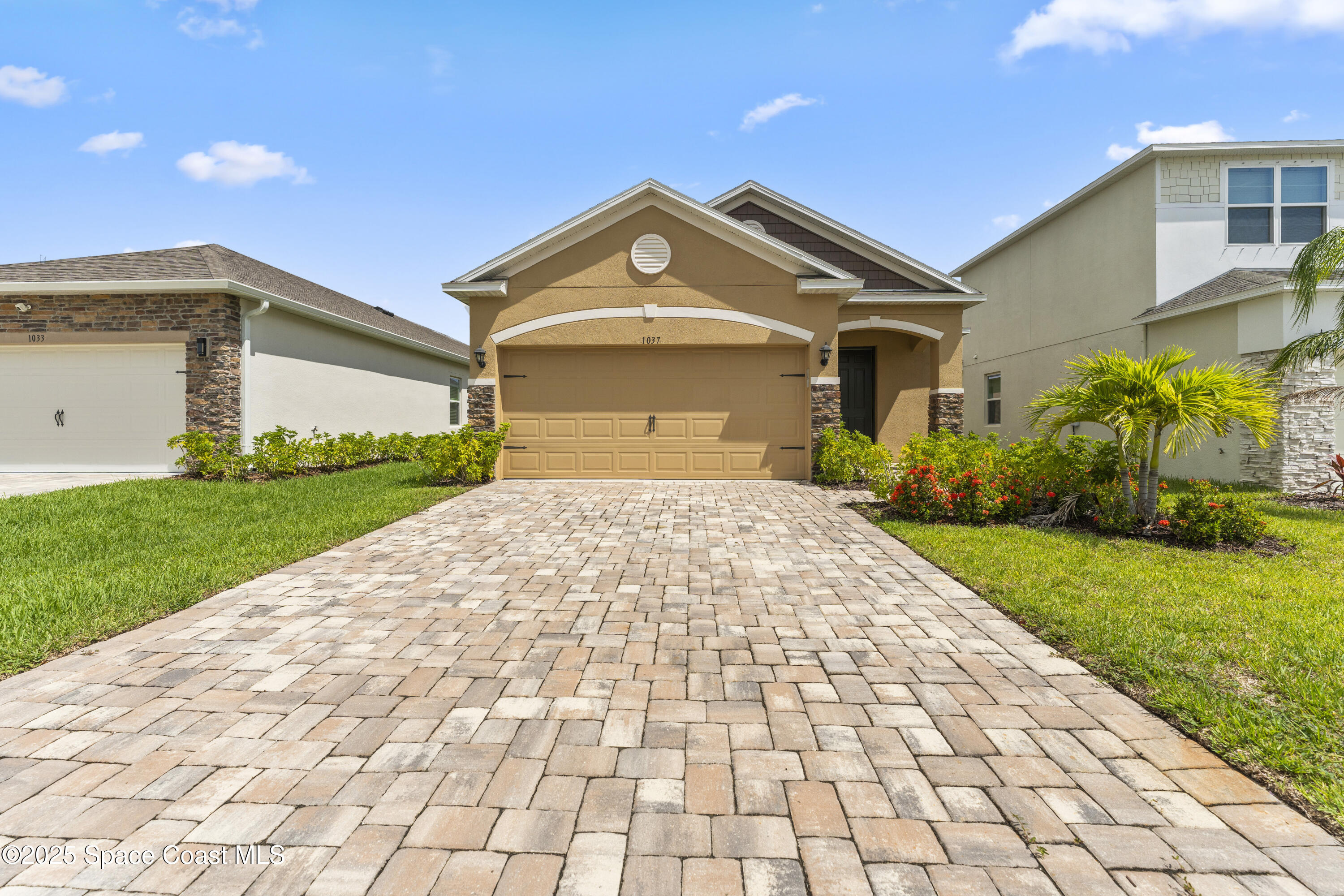 a front view of a house with a yard and garage