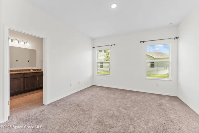 a view of an empty room and a window