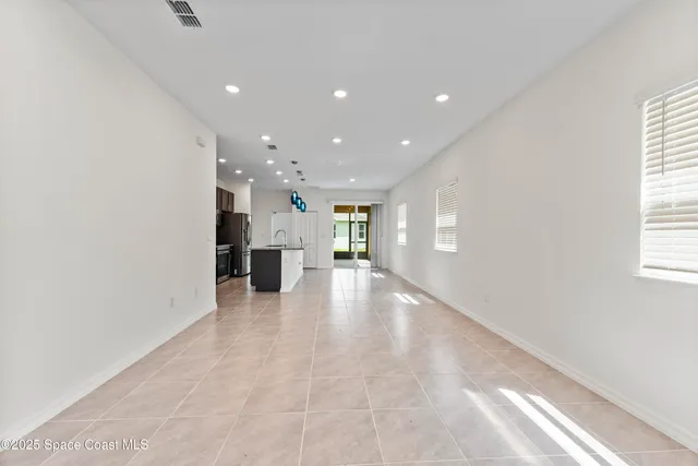 a view of a kitchen with a refrigerator and a window