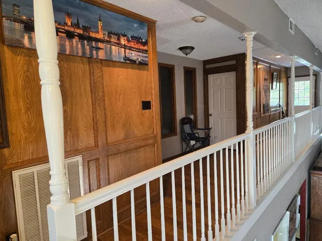 a view of a brick house with wooden floor and windows