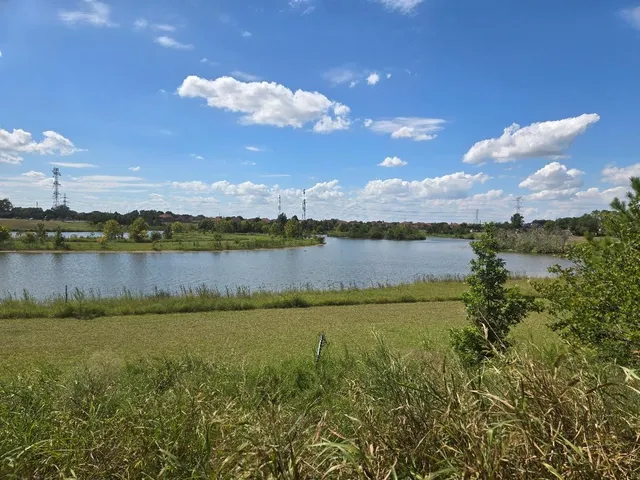 a view of a lake with houses in the back