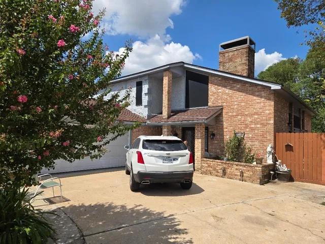 a car parked in front of white house