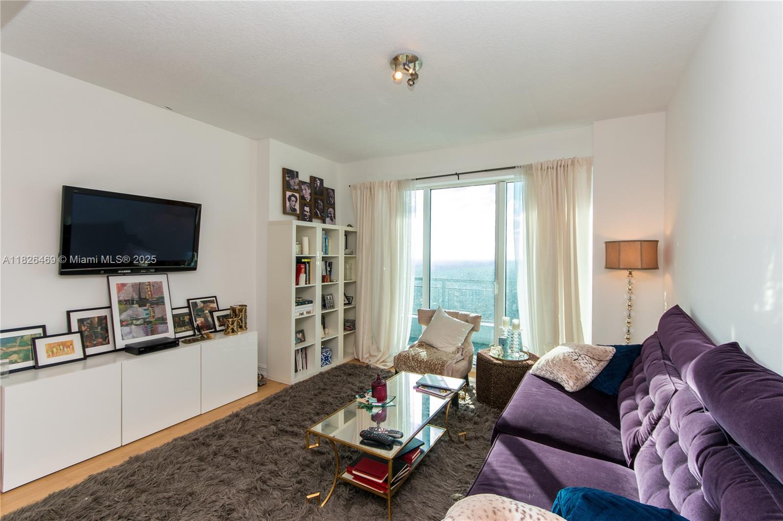 60 Southwest 13th Street, Unit 3805 Miami, FL 33130 - Photo 6 of 14 a living room with furniture and a flat screen tv