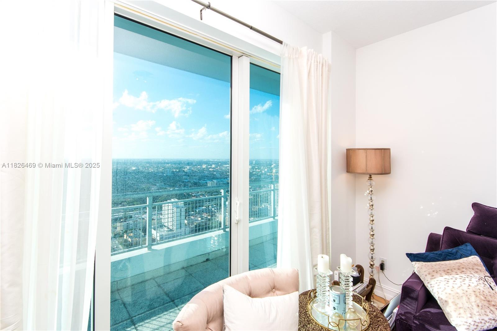 60 Southwest 13th Street, Unit 3805 Miami, FL 33130 - Photo 8 of 14 a living room with furniture and a floor to ceiling window