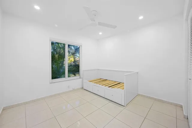 an empty room with windows and closet