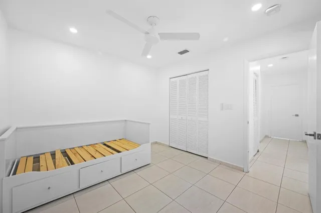 a living room with a couch and a book shelf