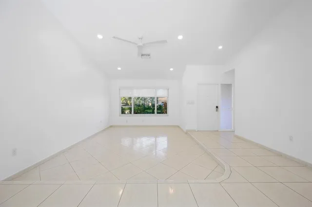 an empty room with garage and windows