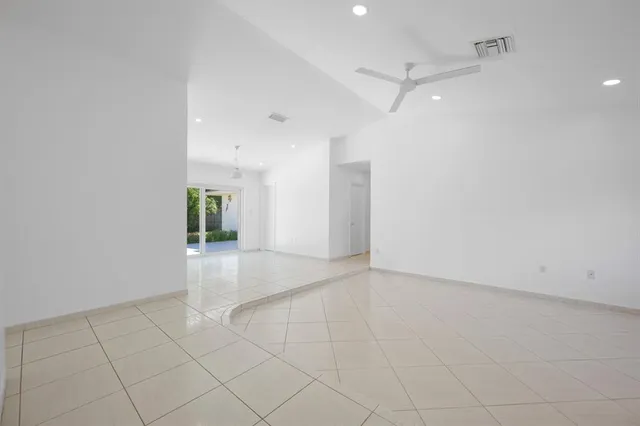 an empty room with a empty space and windows