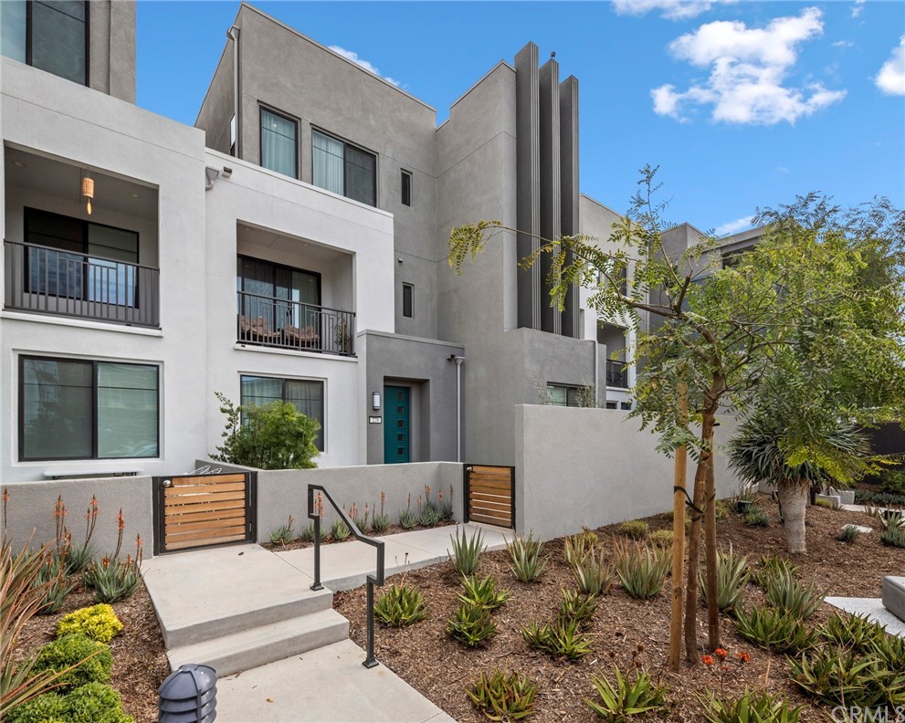 228 Novel Irvine, CA 92618 - Photo 1 of 1 a view of a building with potted plants and a bench