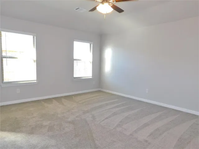 a bathroom with a tub a sink and mirror