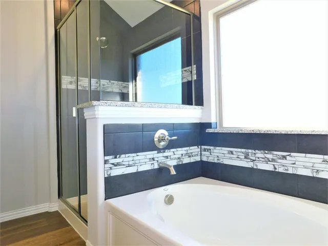a bathroom with a granite countertop sink mirror vanity and toilet