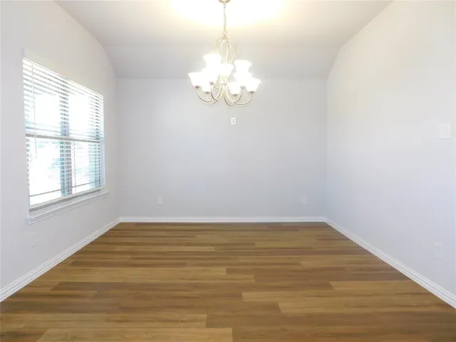a view of a room with wooden floor and window