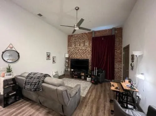 a bedroom with furniture and a mirror