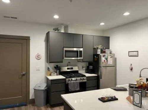 a kitchen with a refrigerator and a stove