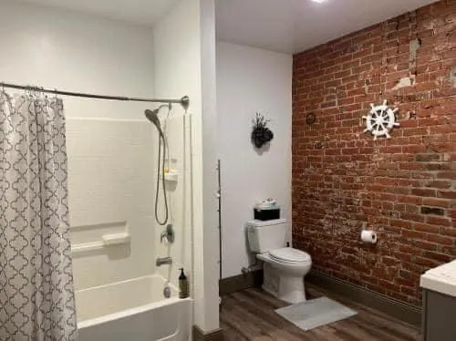 a bathroom with a toilet and a shower