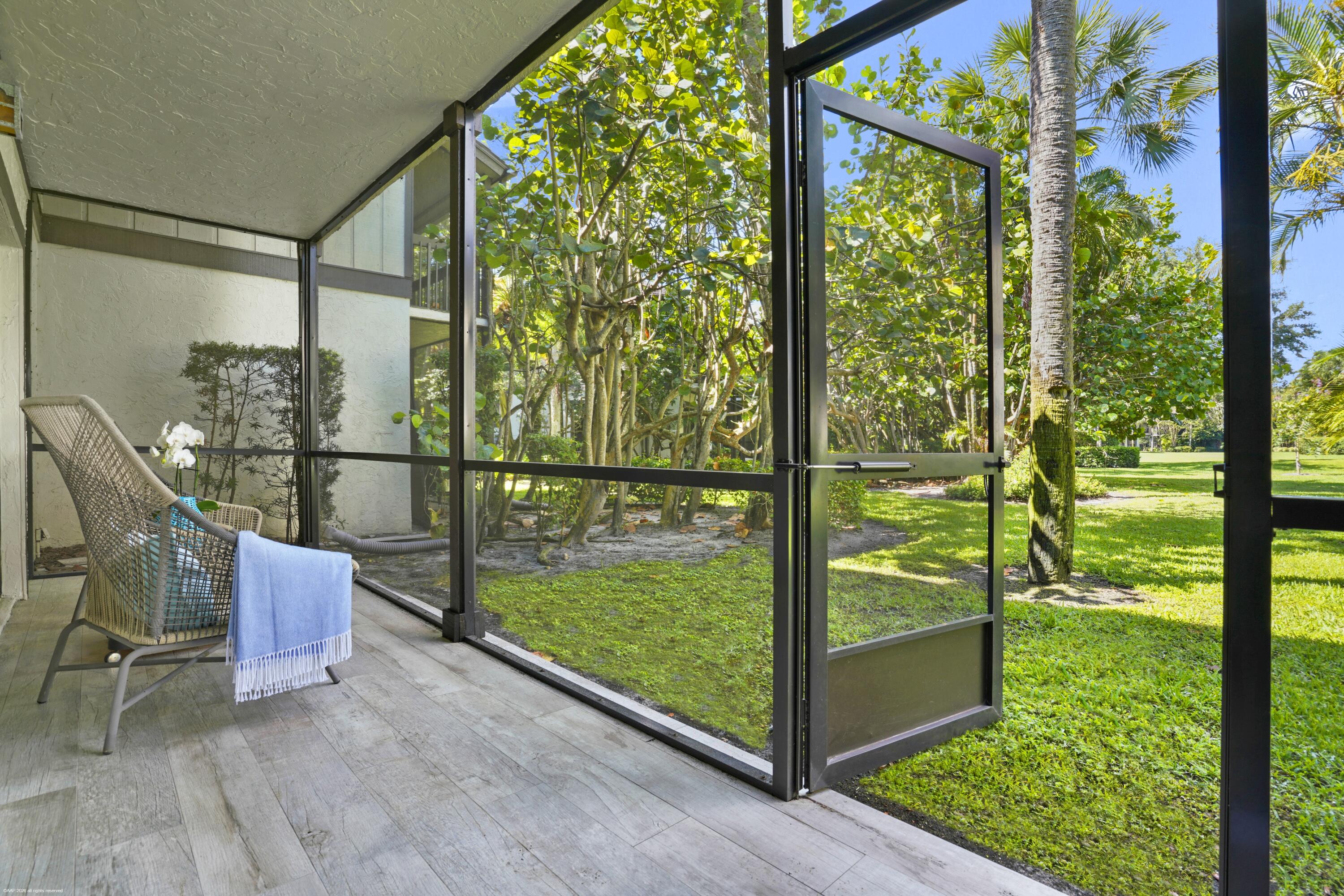13334 Polo Club Road, Unit 234 Wellington, FL 33414 - Photo 19 of 41 a view of a bench in the garden