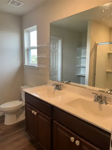 a bathroom with a toilet and a shower curtain