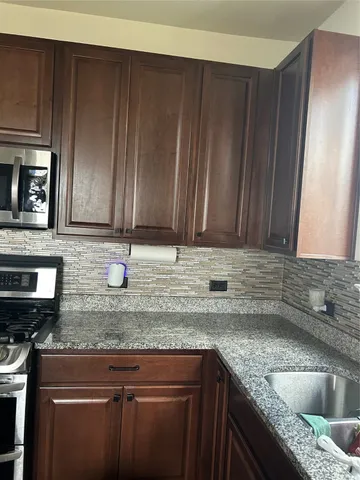 a view of a hallway with wooden floor fireplace and living room