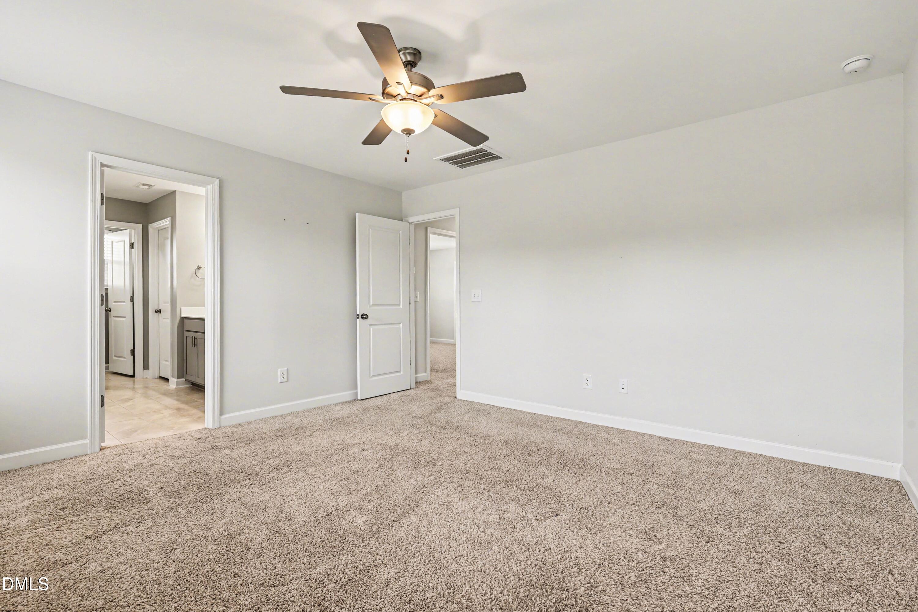 90 Rigsby Avenue Four Oaks, NC 27524 - Photo 29 of 43 an empty room with a chandelier fan and closet area