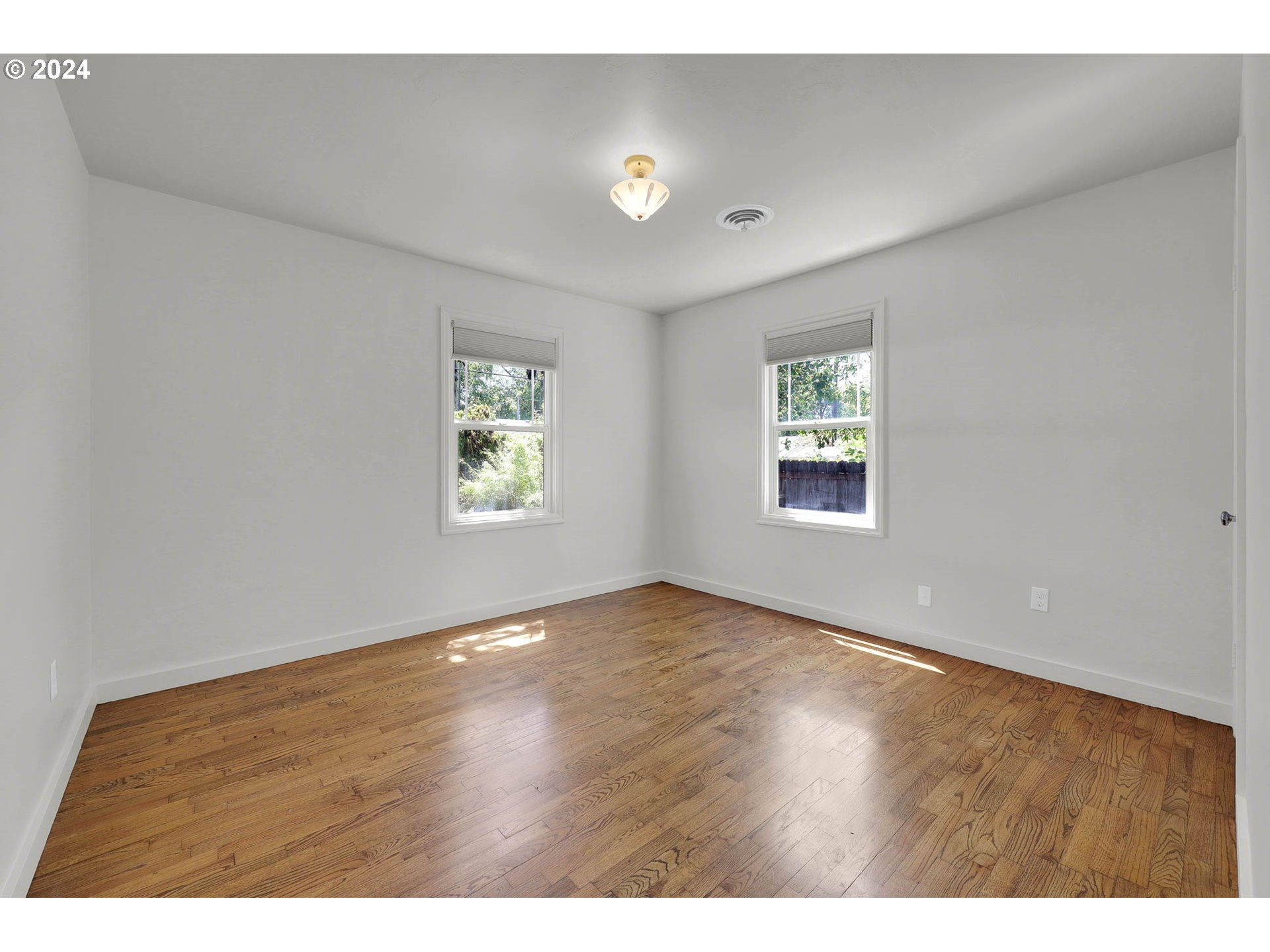 1325 Modoc Street Springfield, OR 97477 - Photo 24 of 36 an empty room with wooden floor and windows