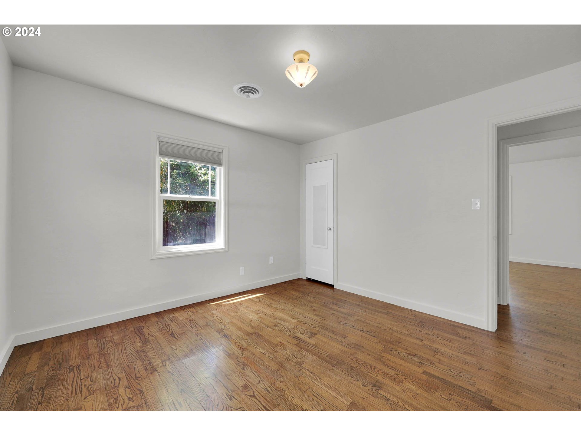 1325 Modoc Street Springfield, OR 97477 - Photo 26 of 36 a view of an empty room with a window and wooden floor