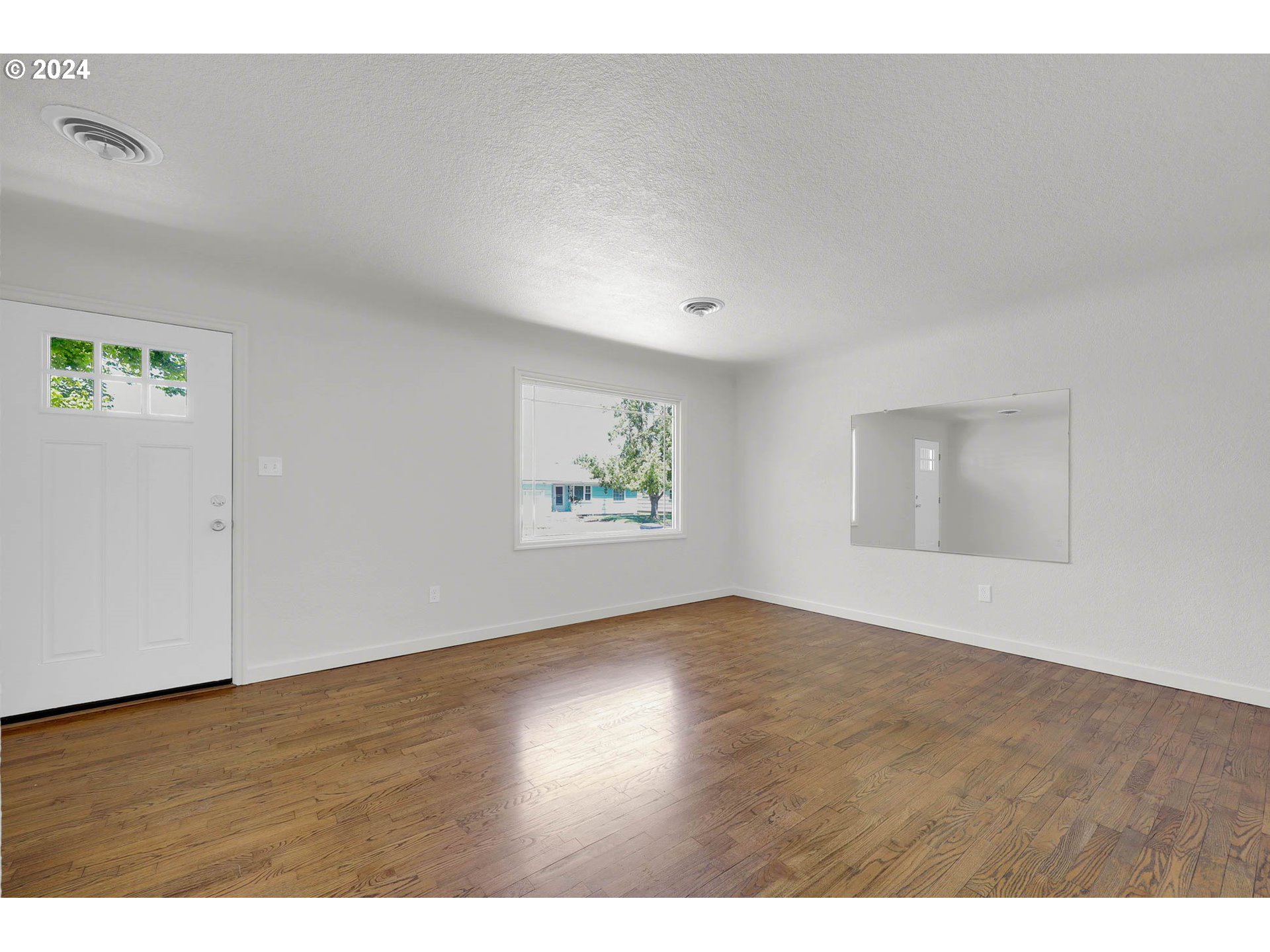 1325 Modoc Street Springfield, OR 97477 - Photo 5 of 36 a view of an empty room with wooden floor and window