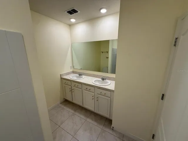 a bathroom with a sink and mirror