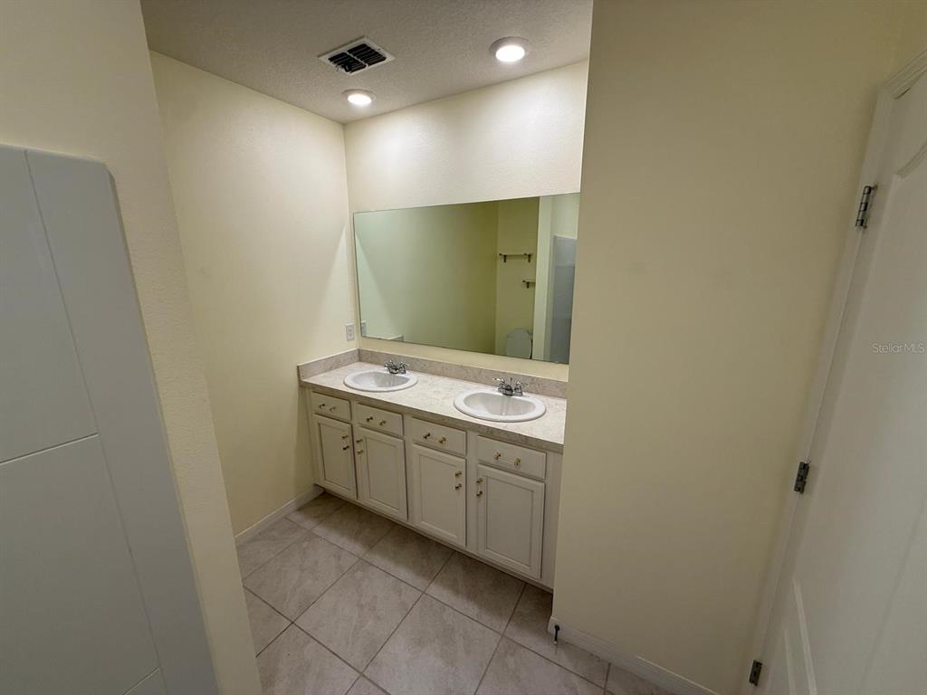 2617 Harmonia Hammock Road Harmony, FL 34773 - Photo 17 of 36 a bathroom with a sink and mirror