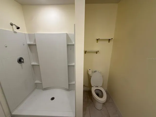 a bathroom with a shower and toilet