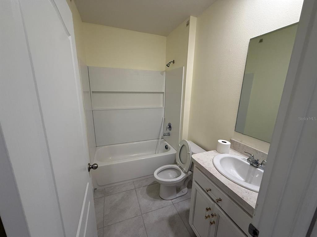 2617 Harmonia Hammock Road Harmony, FL 34773 - Photo 20 of 36 a bathroom with a granite countertop sink toilet and shower