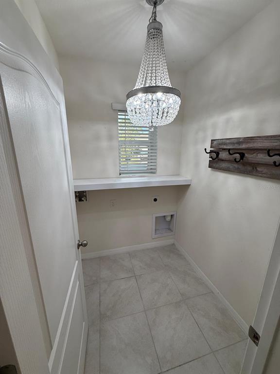 2617 Harmonia Hammock Road Harmony, FL 34773 - Photo 32 of 36 a view of a hallway with a chandelier