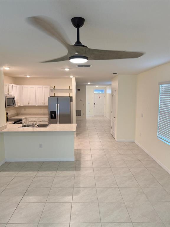 2617 Harmonia Hammock Road Harmony, FL 34773 - Photo 8 of 36 a room with stainless steel appliances kitchen island granite countertop a rug a stove a microwave and a refrigerator