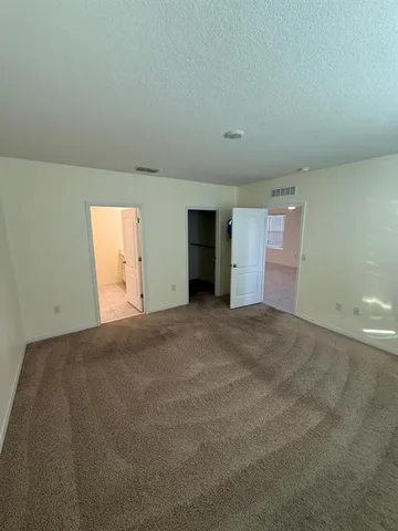 a view of an empty room and a window