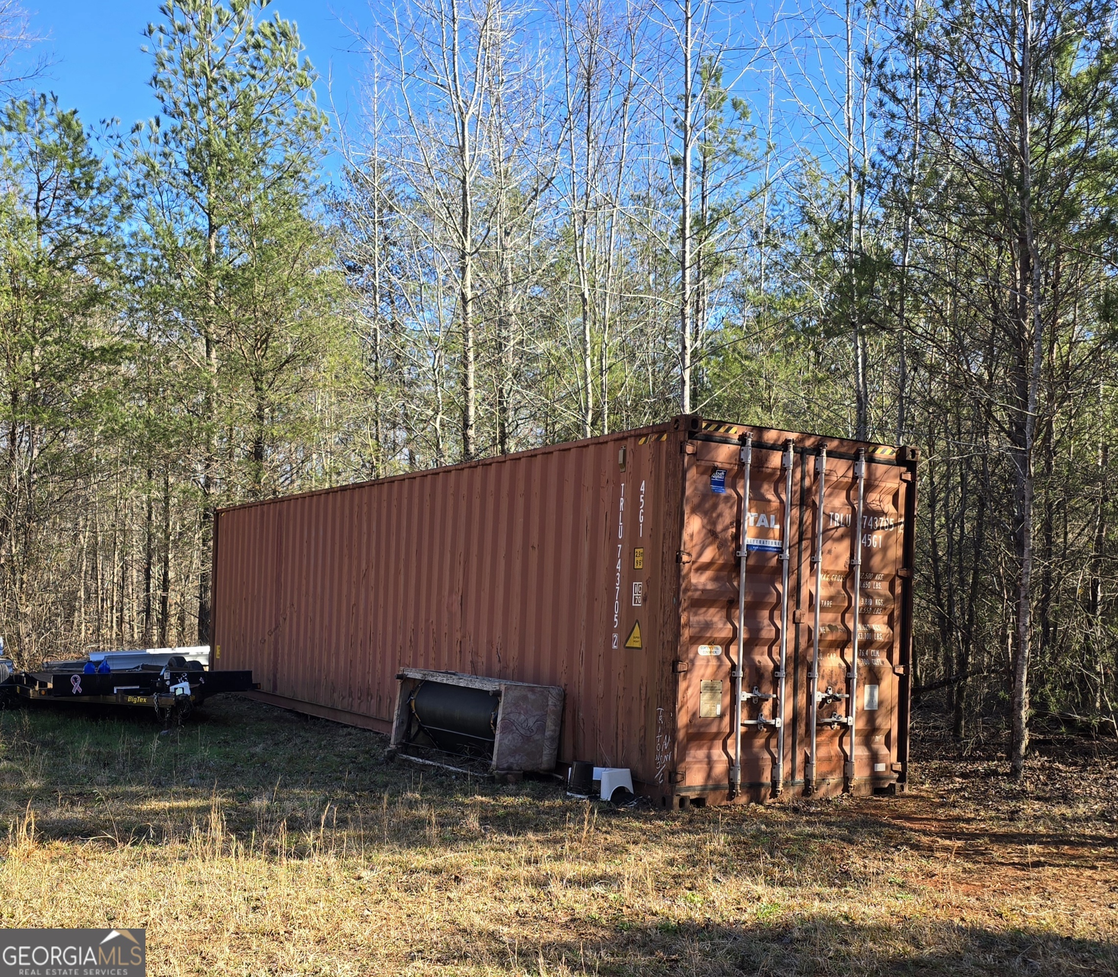 1183 Wilson Bridge Road Homer, GA 30547 - Photo 11 of 23 a view of a backyard with large trees and wooden fence