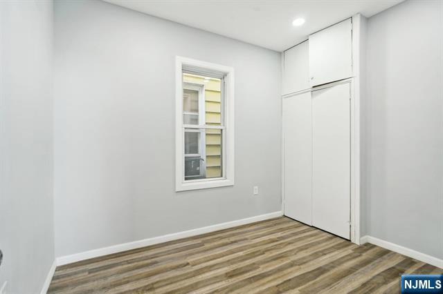 127 Randolph Avenue, Unit 2 Jersey City, NJ 07305 - Photo 12 of 17 an empty room with windows and closet