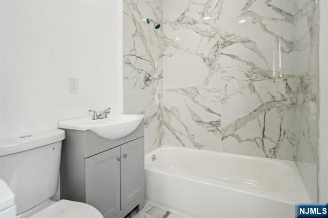 127 Randolph Avenue, Unit 2 Jersey City, NJ 07305 - Photo 15 of 17 a bathroom with a sink a toilet and bathtub