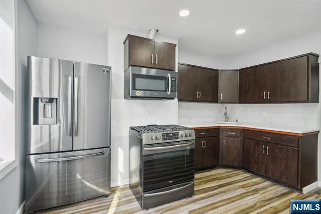 a kitchen with a refrigerator sink and microwave