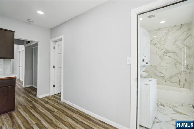 127 Randolph Avenue, Unit 2 Jersey City, NJ 07305 - Photo 4 of 17 a view of a hallway with wooden floor and staircase