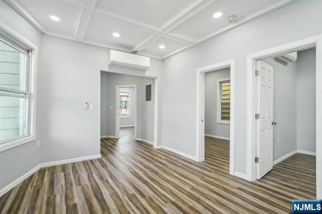 127 Randolph Avenue, Unit 2 Jersey City, NJ 07305 - Photo 6 of 17 wooden floor in an empty room with a window