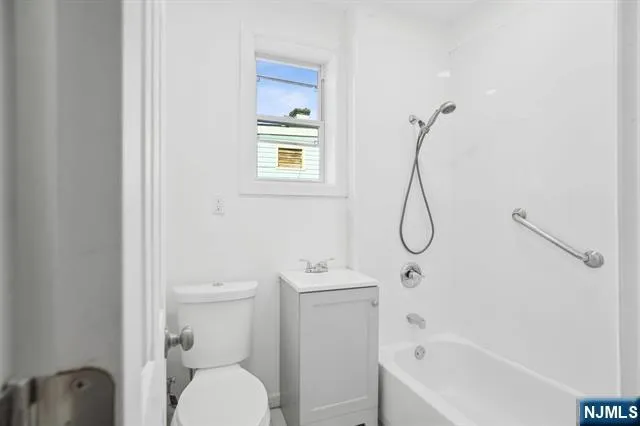 a bathroom with a toilet sink and shower