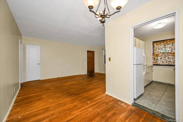 a view of a big room with wooden floor and cabinets