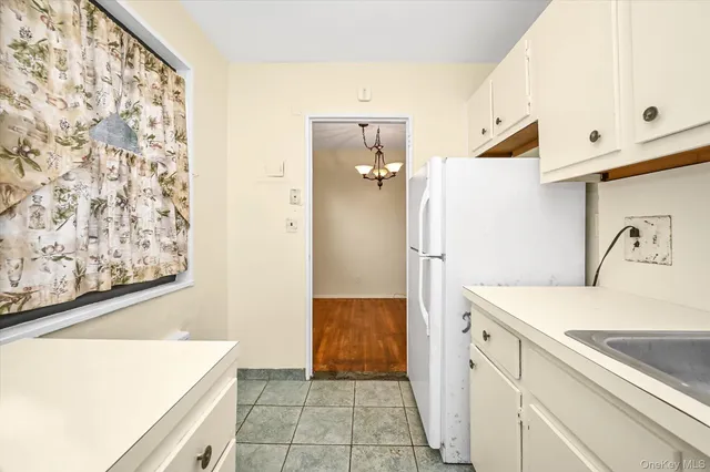a kitchen with a refrigerator and a sink