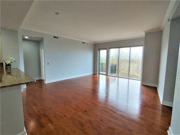 wooden floor in an empty room with a window