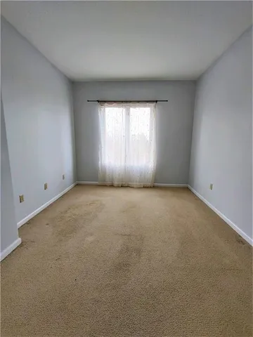 an empty room with a empty space and windows