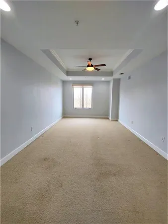 a view of a livingroom with a ceiling fan and window