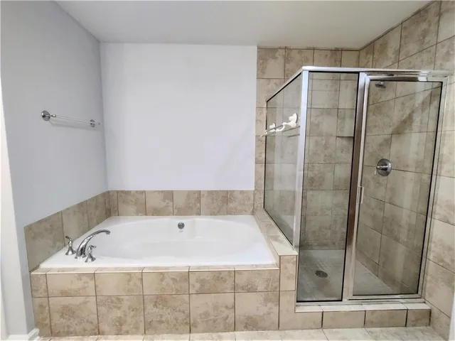 a bathroom with a bath tub and shower