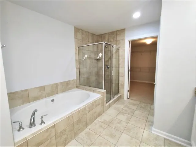 a bathroom with a tub a sink and shower