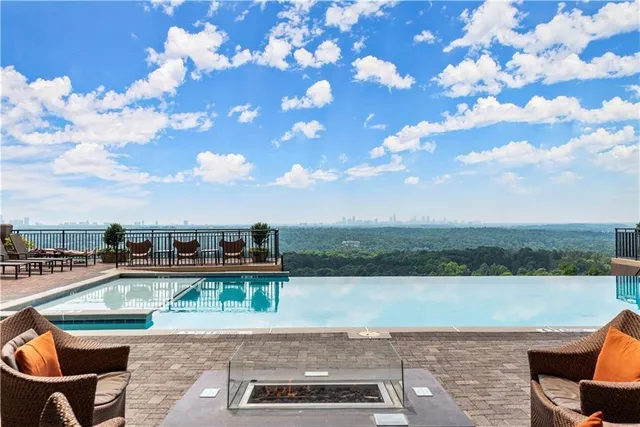 a view of a lake with couches in the patio